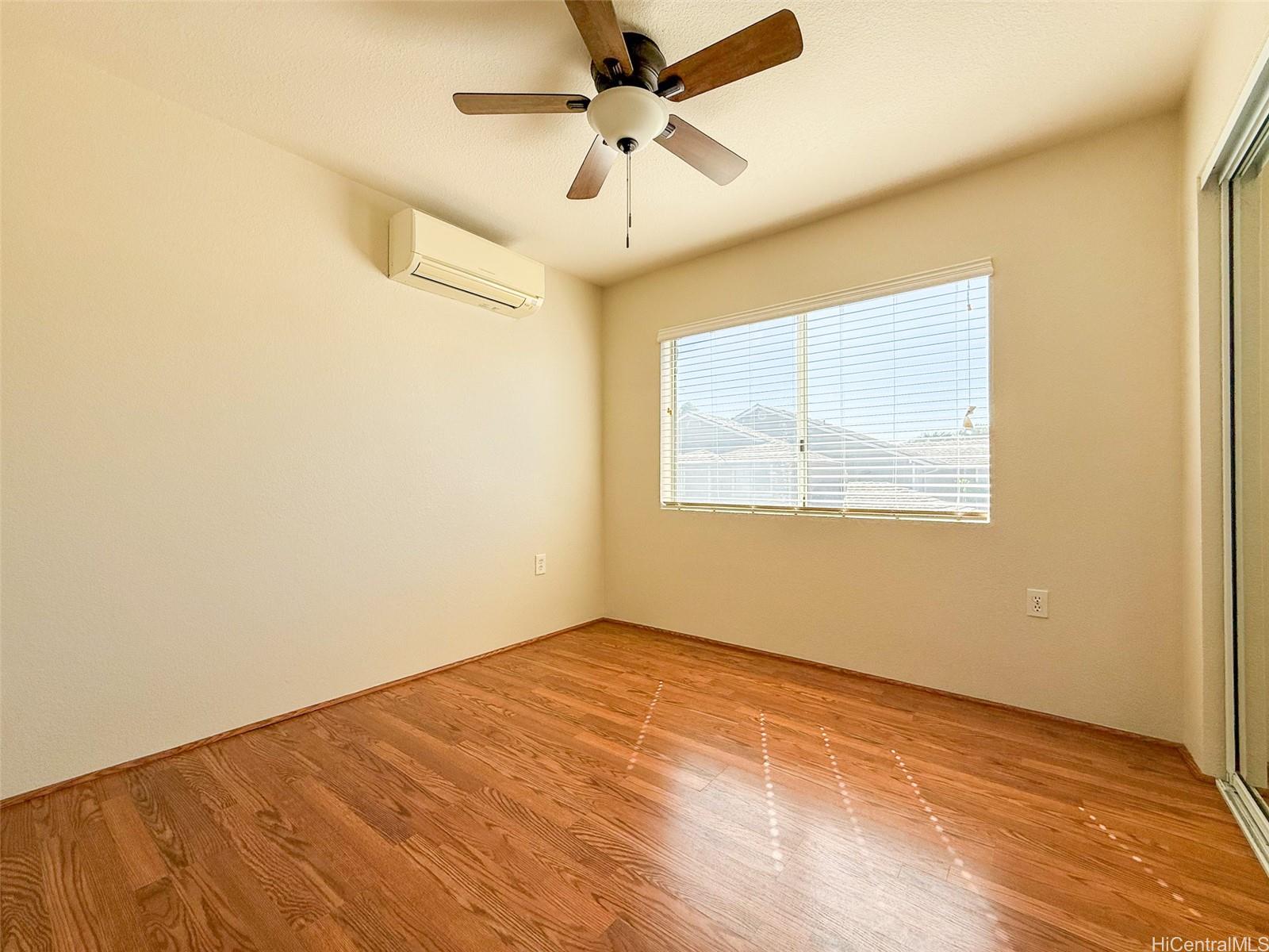 92-1519 Ali'inui Drive, Unit 12A Kapolei, HI 96707 - Photo 9 of 25 an empty room with a window and a ceiling fan