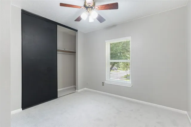 a bathroom with a granite countertop sink and a toilet