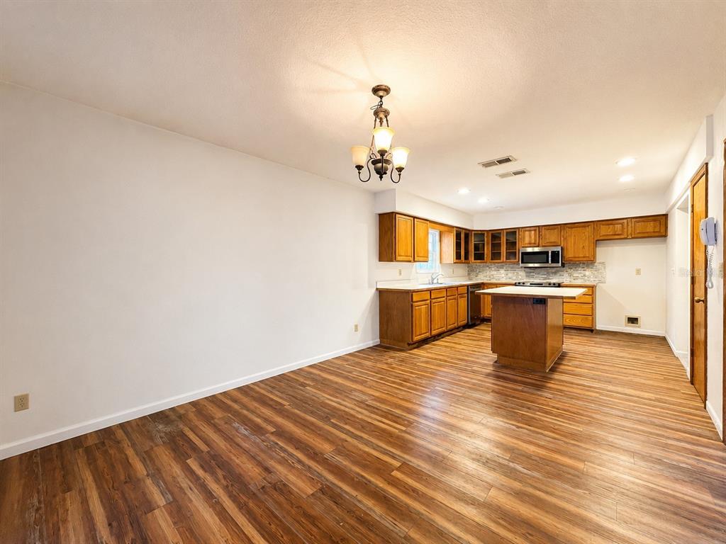 7119 Immokalee Road Keystone Heights, FL 32656 - Photo 13 of 50 a view of kitchen and dining room with wooden floor