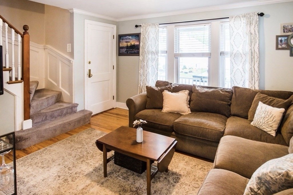 69 Keystone Street, Unit 1 Boston, MA 02132 - Photo 5 of 10 a living room with furniture wooden floor and a large window