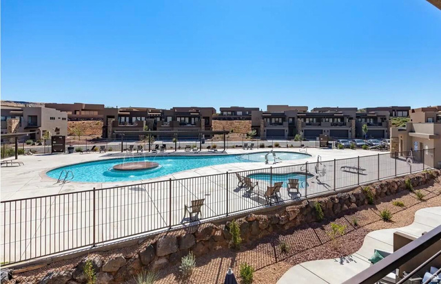 4846 Fishers Is Way St. George, UT 84770 - Photo 13 of 13 Resort-style pool area featuring a large swimming pool with a circular water feature, an additional wading pool, and a surrounding concrete deck