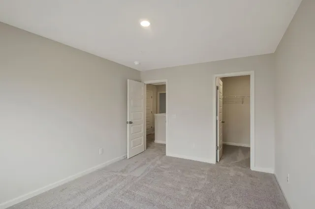 a view of an empty room and closet area