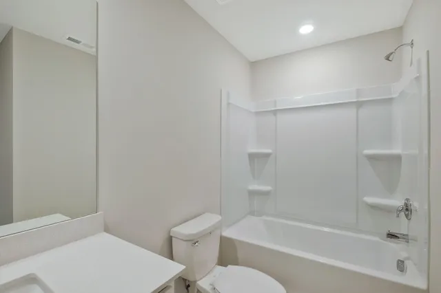 a bathroom with a toilet and a bathtub