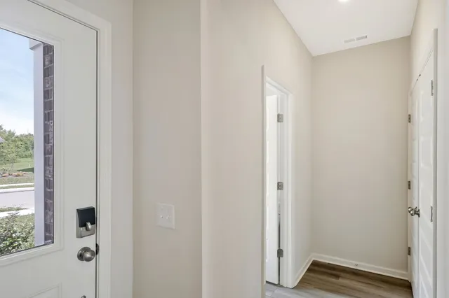 a view of front door with wooden floor