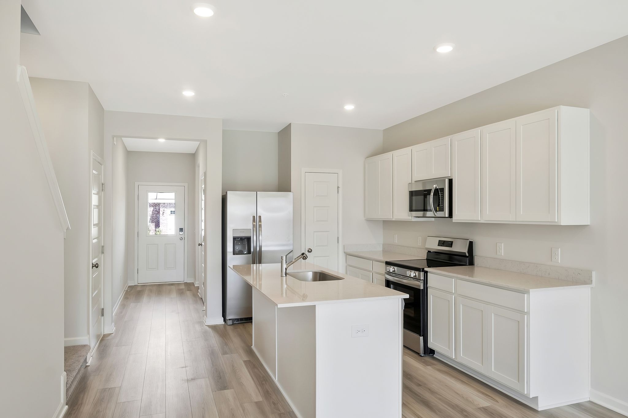 419 Alcott Way Spring Hill, TN 37174 - Photo 4 of 25 a kitchen with a sink a refrigerator and cabinets