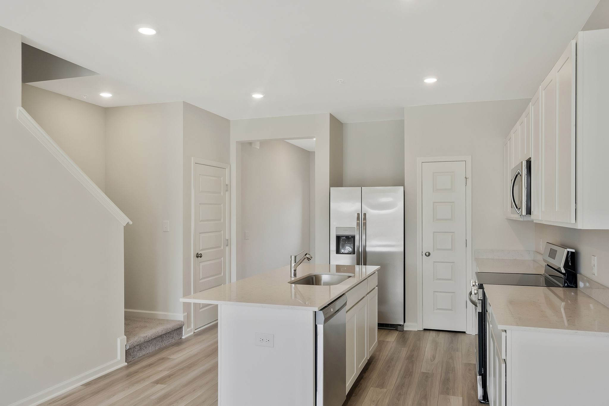 419 Alcott Way Spring Hill, TN 37174 - Photo 5 of 25 a kitchen with a sink a refrigerator a stove and wooden floor