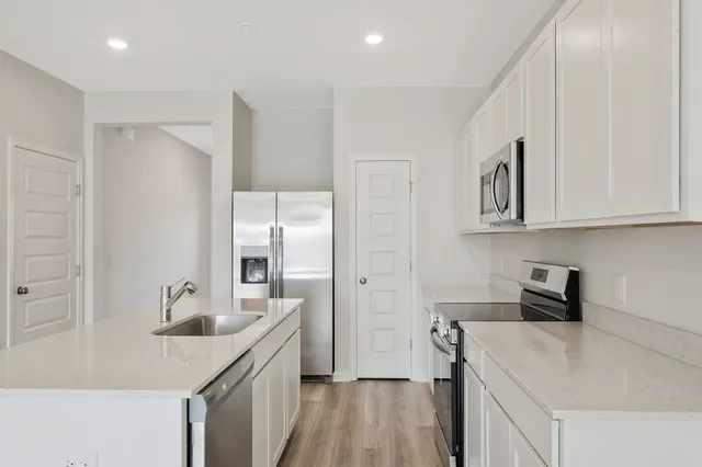 a kitchen with a sink stove and refrigerator
