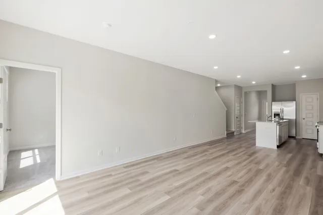 a view of a kitchen with a sink and wooden floor