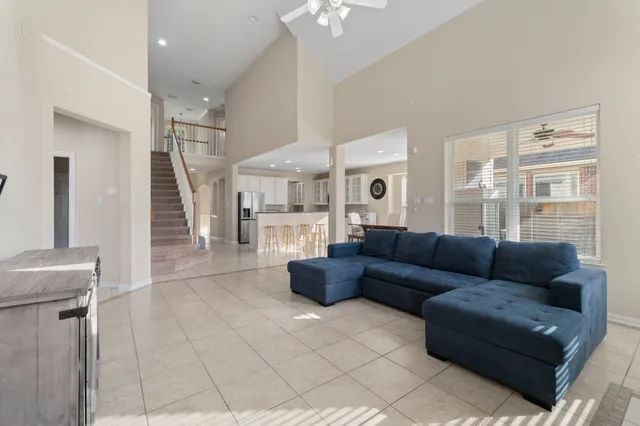 a living room with furniture and a chandelier