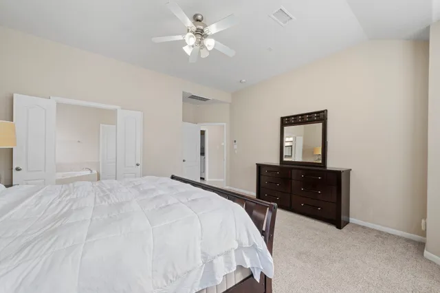 a bedroom with a bed and a dresser