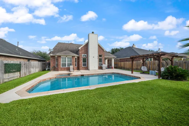 a view of pool with a yard