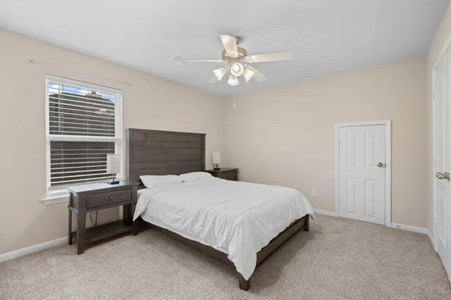 a bedroom with a bed dresser and a window