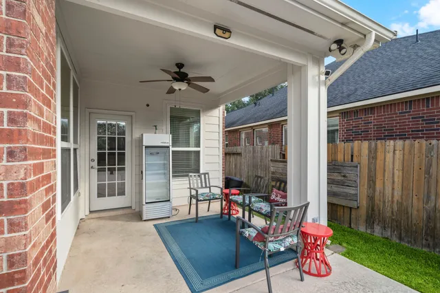 a view of a livingroom with furniture and floor to ceiling window