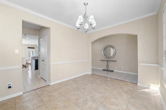 a view of an empty room with a chandelier