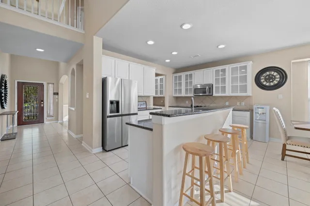 a kitchen with a refrigerator and a table