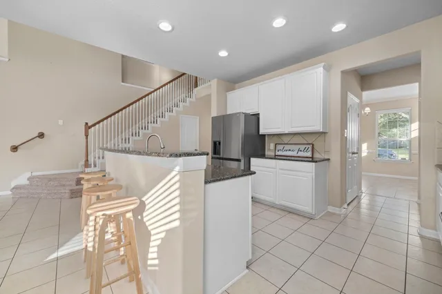 a view of kitchen with furniture and refrigerator