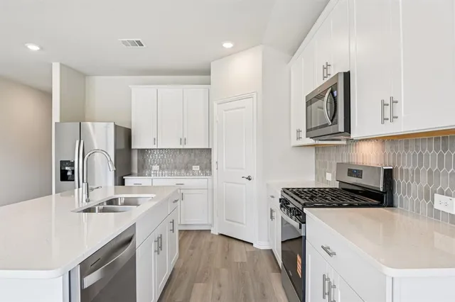 a kitchen with a sink stove and refrigerator