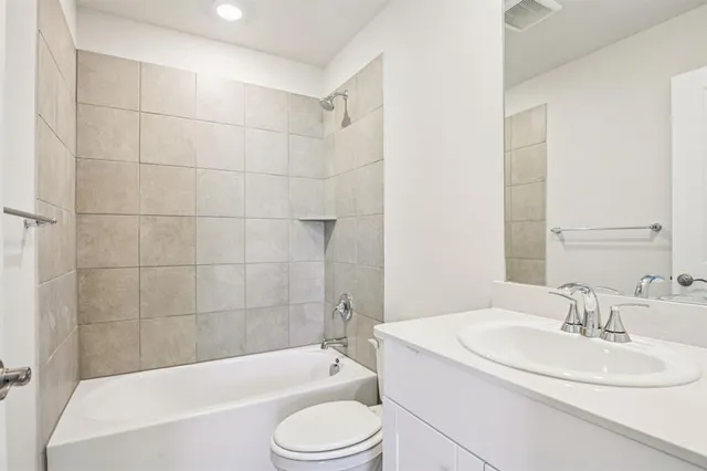 a bathroom with a sink a toilet and bathtub