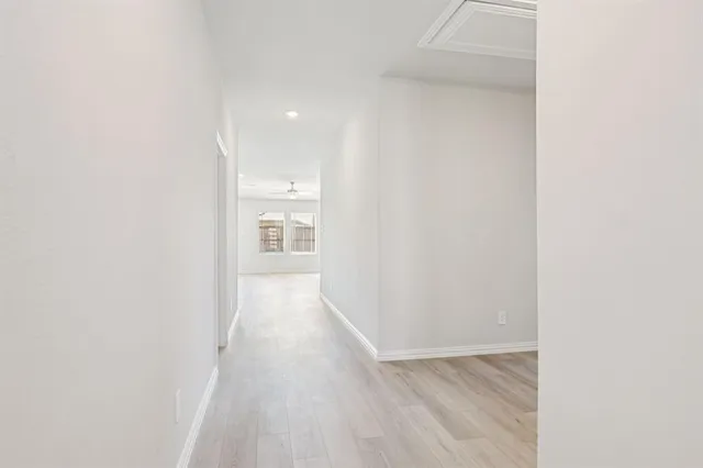 a view of a hallway with wooden floor