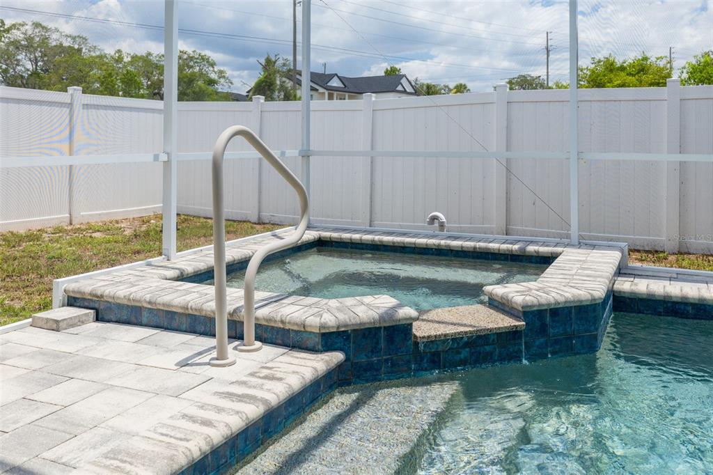 7242 Landmark Drive Spring Hill, FL 34606 - Photo 21 of 45 a view of a swimming pool with a lounge chairs