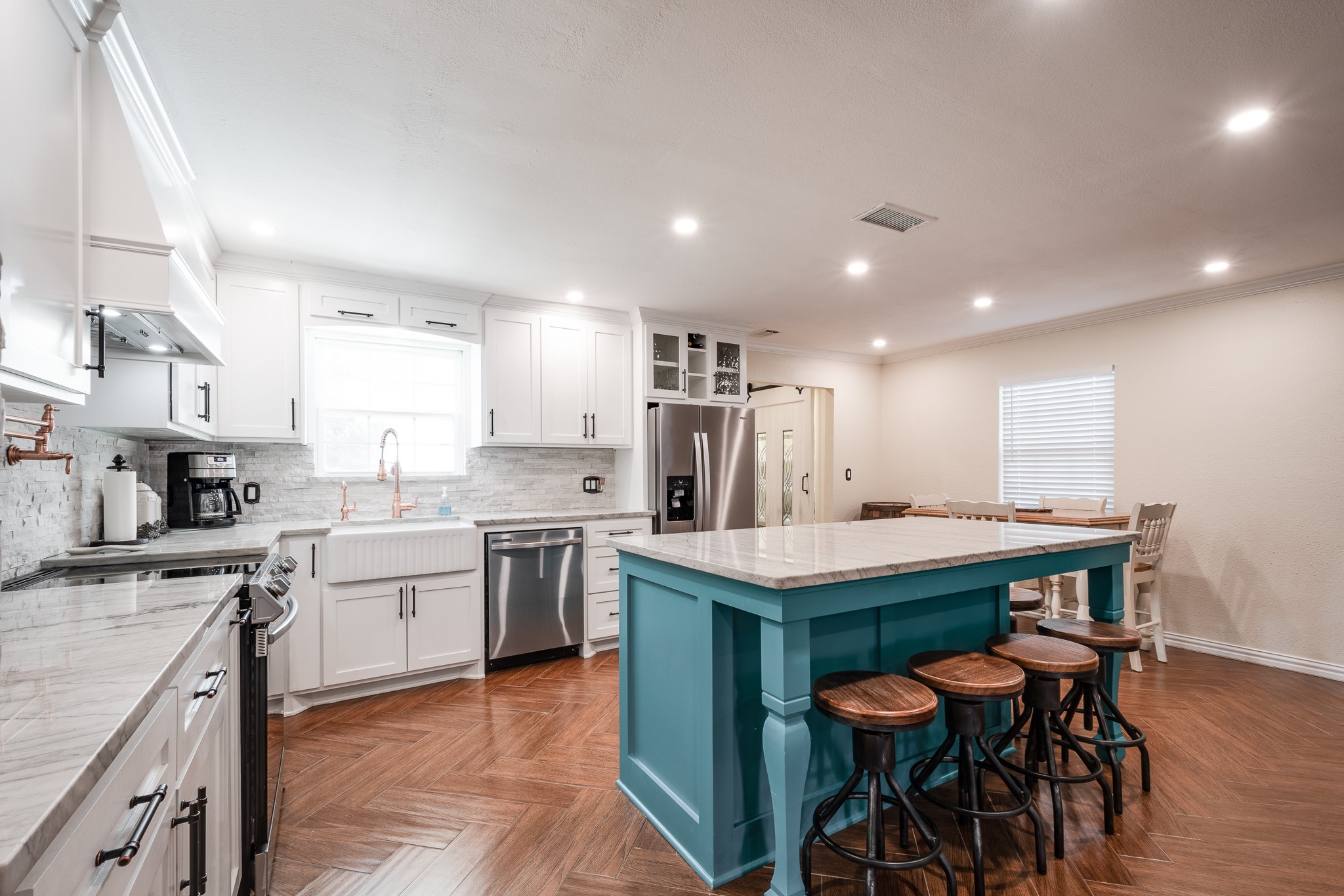 11620 Fostoria Road Cleveland, TX 77328 - Photo 7 of 26 a kitchen with stainless steel appliances kitchen island granite countertop a table chairs sink and cabinets