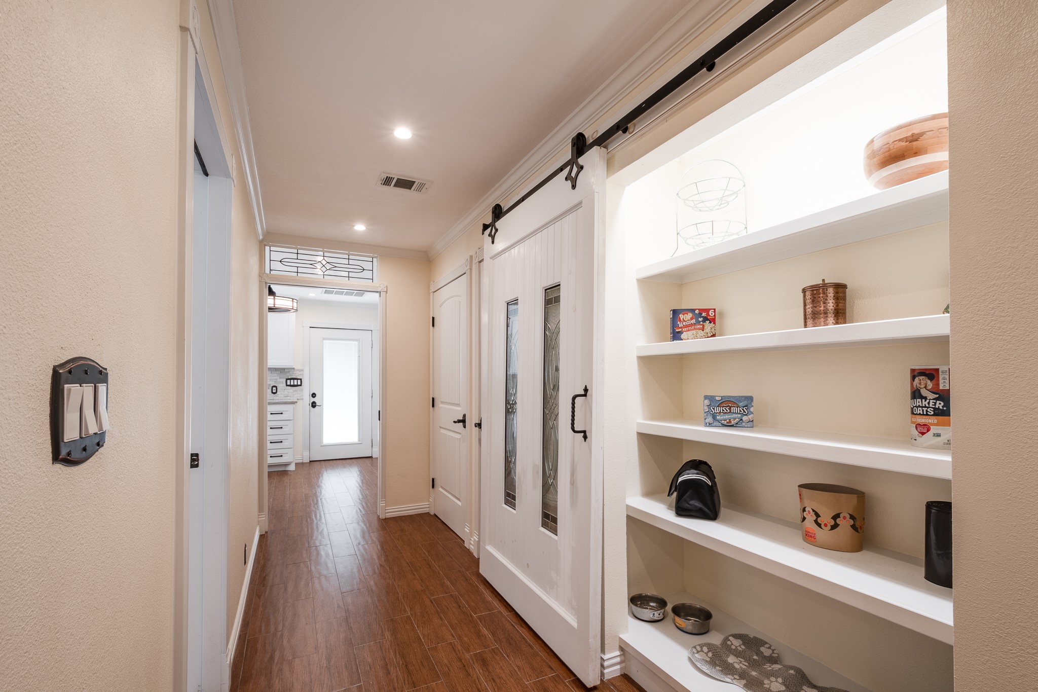 11620 Fostoria Road Cleveland, TX 77328 - Photo 10 of 26 a hallway with cabinet and wooden floor