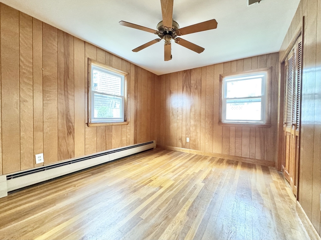 7 Roland Road Peabody, MA 01960 - Photo 16 of 24 a view of an empty room with a window and wooden floor