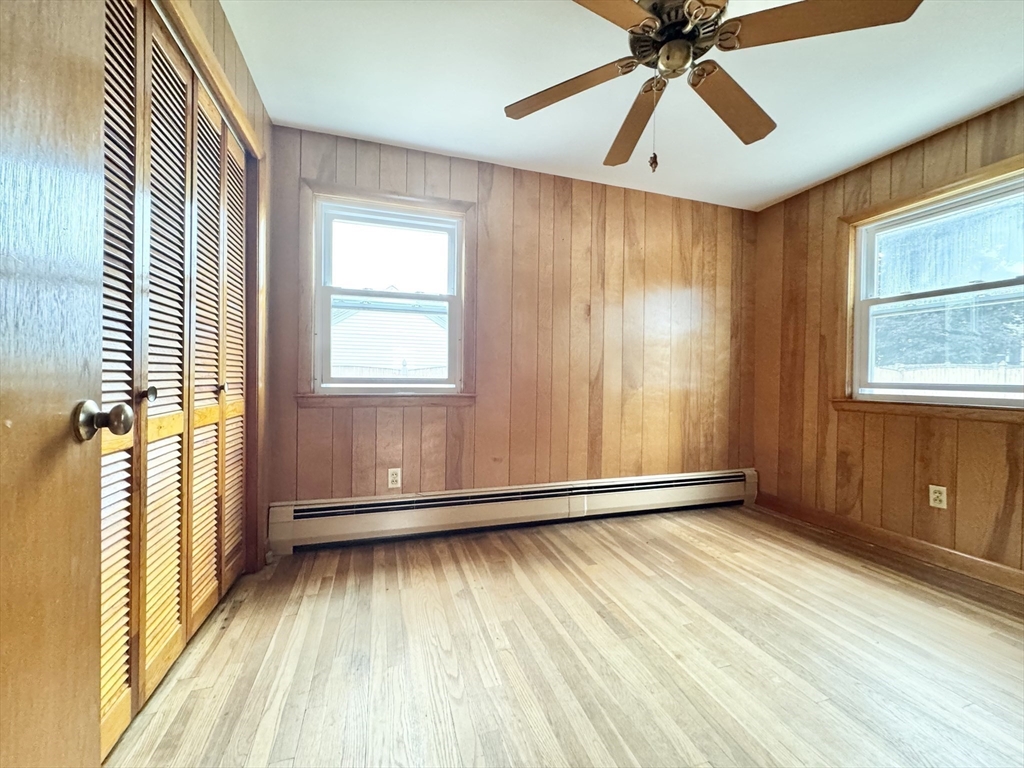 7 Roland Road Peabody, MA 01960 - Photo 17 of 24 an empty room with wooden floor fan and windows