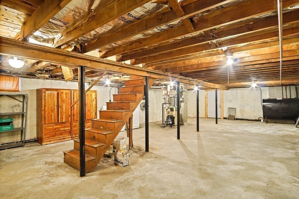 7 Roland Road Peabody, MA 01960 - Photo 19 of 24 a view of a garage with wooden table and chairs