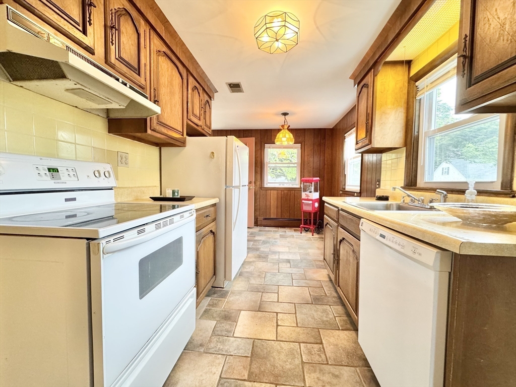 7 Roland Road Peabody, MA 01960 - Photo 2 of 24 a kitchen with stainless steel appliances granite countertop a stove a sink and a refrigerator