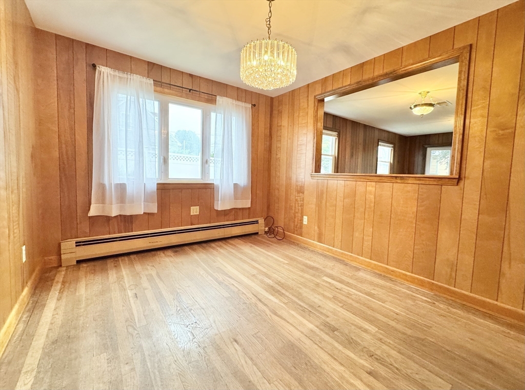 7 Roland Road Peabody, MA 01960 - Photo 7 of 24 a view of an empty room with wooden floor and a window