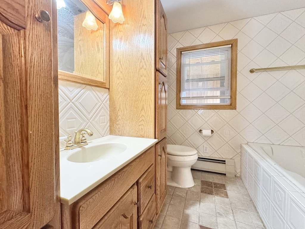 7 Roland Road Peabody, MA 01960 - Photo 10 of 24 a bathroom with a sink toilet and shower