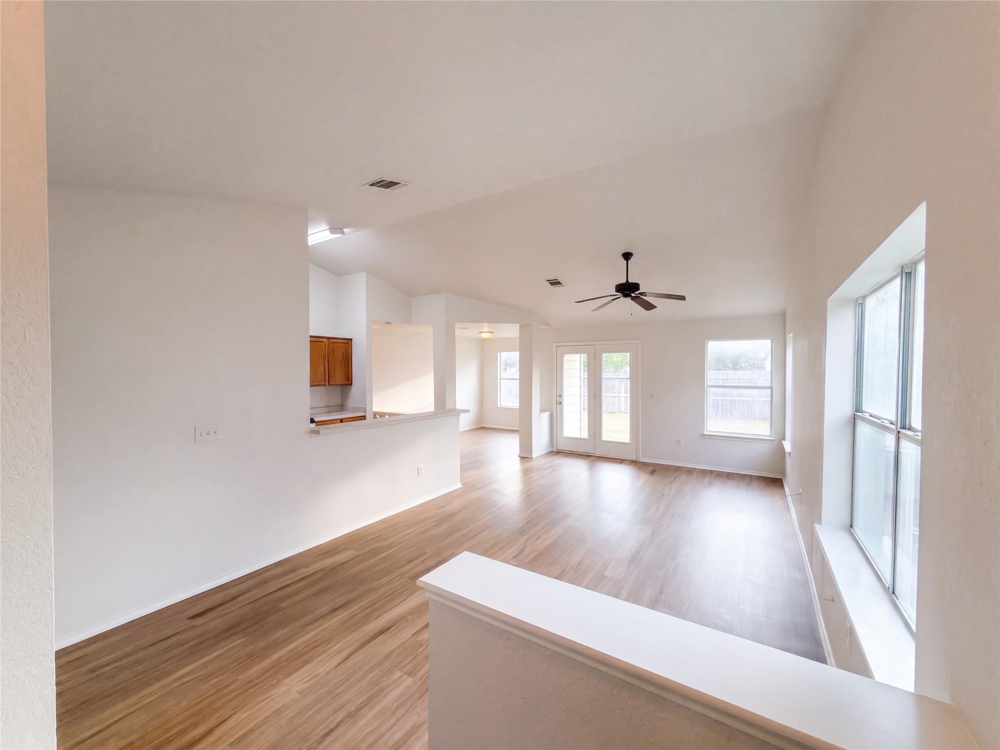 Gleaming wood floors anchor a spacious open layout with abundant natural light.