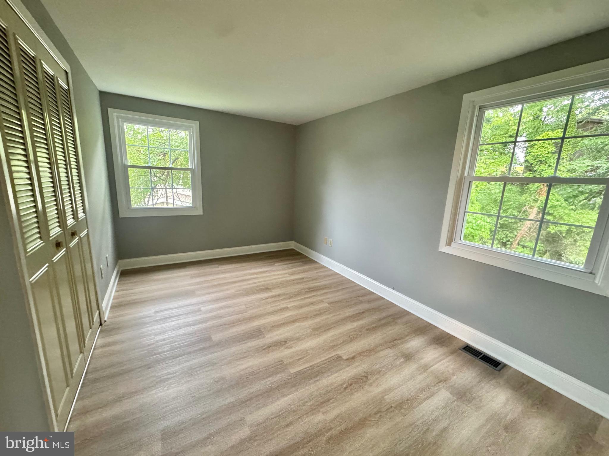 4908 Rocky Spring Lane Bowie, MD 20715 - Photo 27 of 36 an empty room with wooden floor and windows