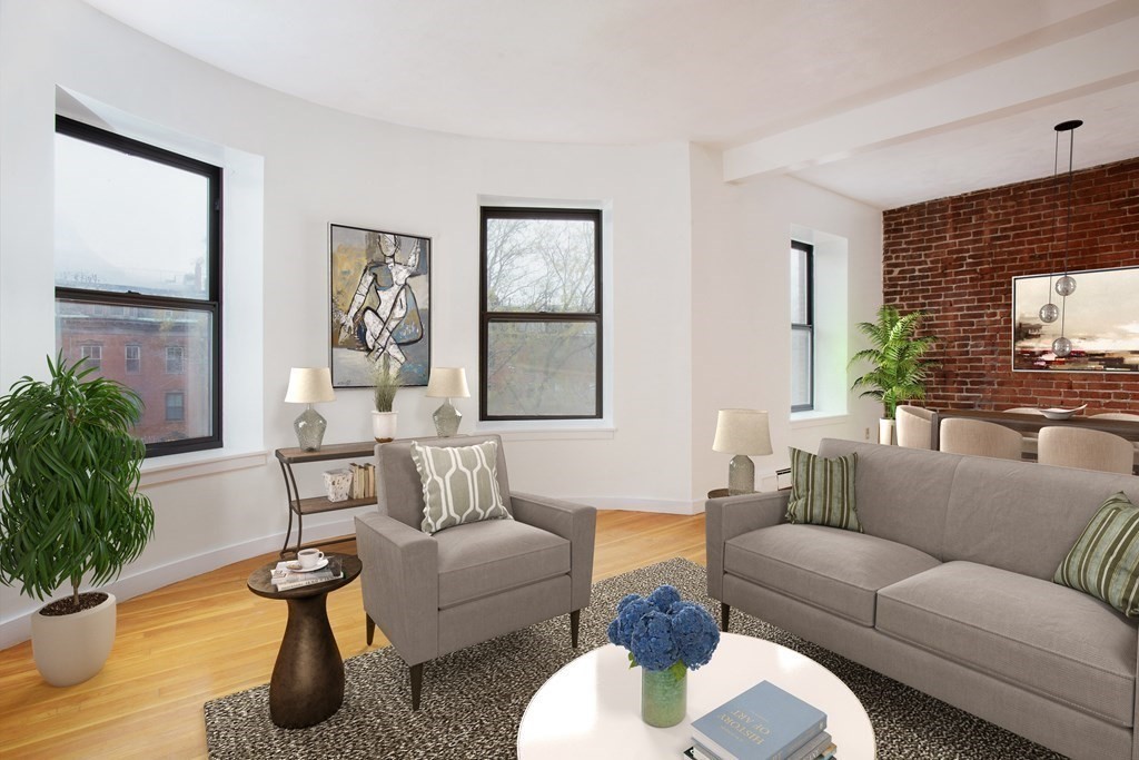 a living room with furniture potted plant and a window