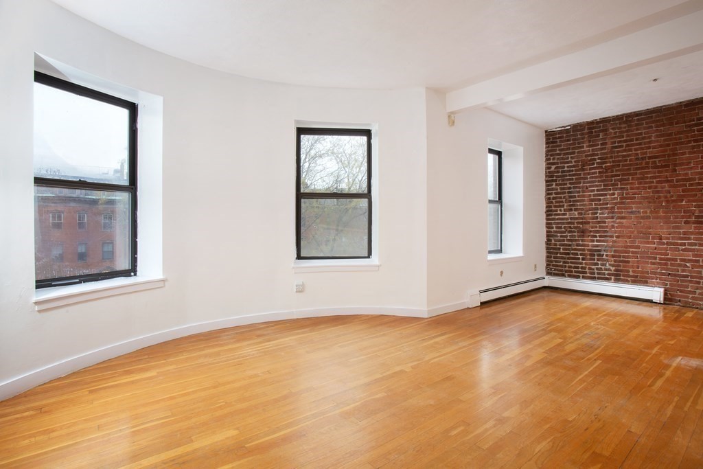 28 Worcester Square, Unit 4 Boston, MA 02118 - Photo 2 of 7 a view of an empty room with window and wooden floor