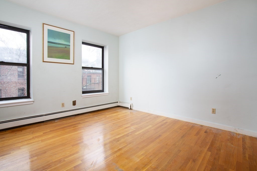 28 Worcester Square, Unit 4 Boston, MA 02118 - Photo 5 of 7 wooden floor in an empty room with a window