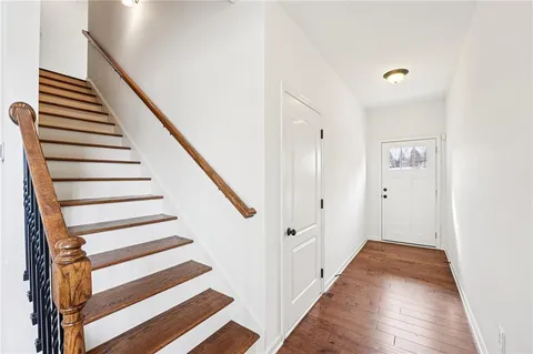 a view of entryway and hall with wooden floor