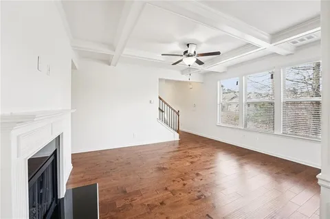a view of a kitchen with granite countertop stainless steel appliances and a large window