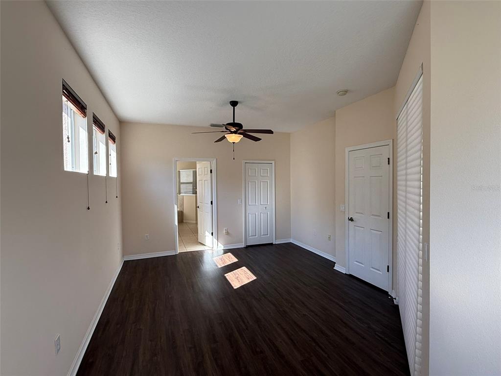 14163 Cattle Egret PIace Lakewood Ranch, FL 34202 - Photo 16 of 50 wooden floor in an empty room with a window