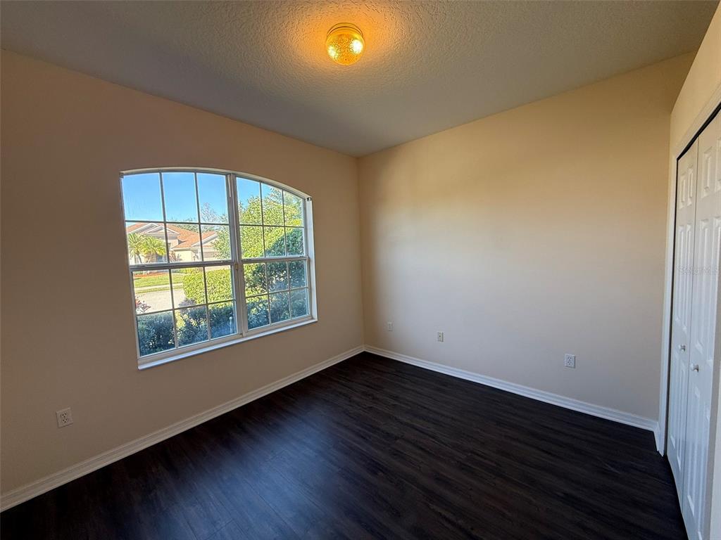 14163 Cattle Egret PIace Lakewood Ranch, FL 34202 - Photo 24 of 50 an empty room with wooden floor and windows