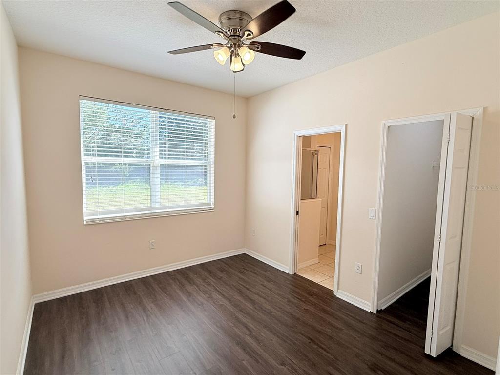 14163 Cattle Egret PIace Lakewood Ranch, FL 34202 - Photo 28 of 50 a view of an empty room with window and wooden floor