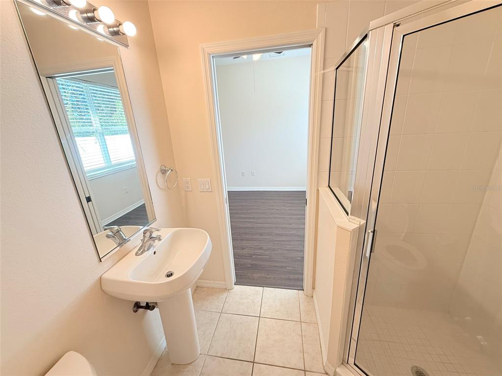 14163 Cattle Egret PIace Lakewood Ranch, FL 34202 - Photo 31 of 50 a bathroom with a sink a mirror and a shower