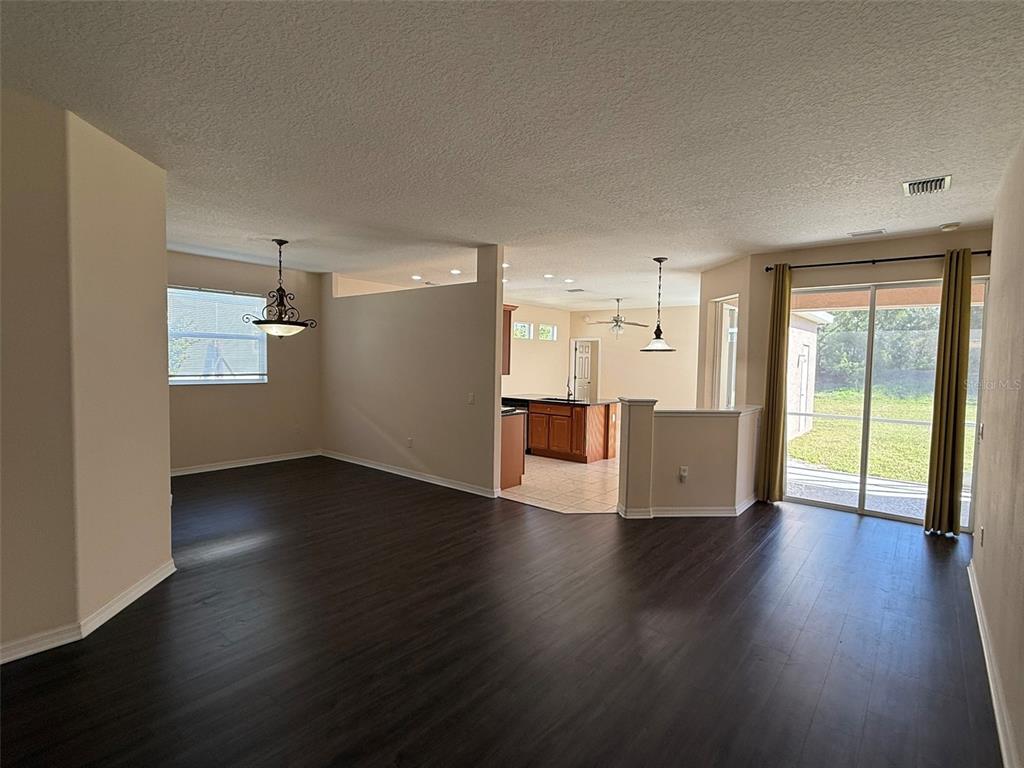 14163 Cattle Egret PIace Lakewood Ranch, FL 34202 - Photo 7 of 50 a view of a big room with wooden floor and windows