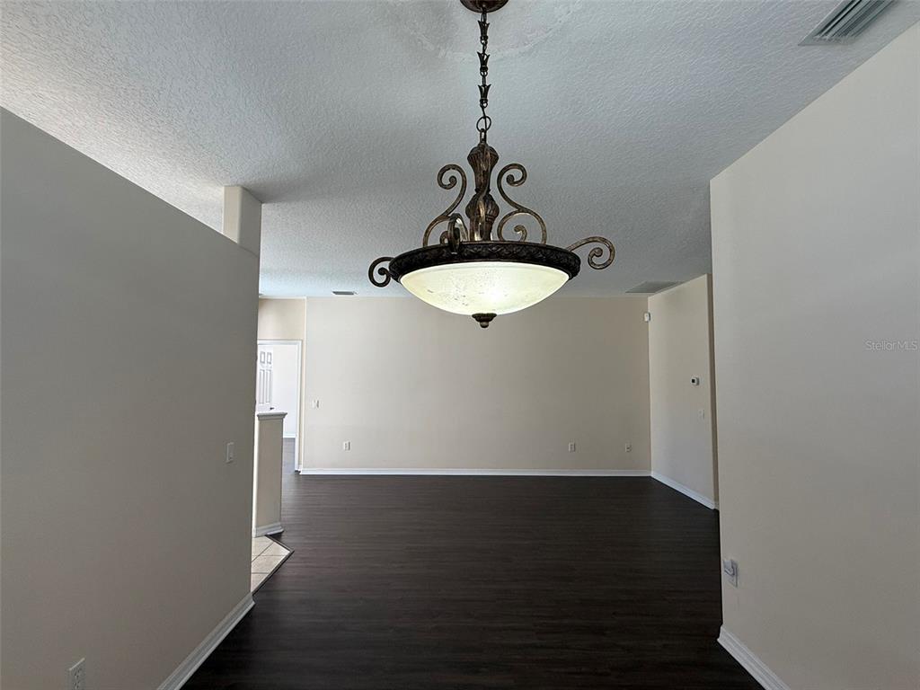 14163 Cattle Egret PIace Lakewood Ranch, FL 34202 - Photo 10 of 50 a view of a room with wooden floor and utility