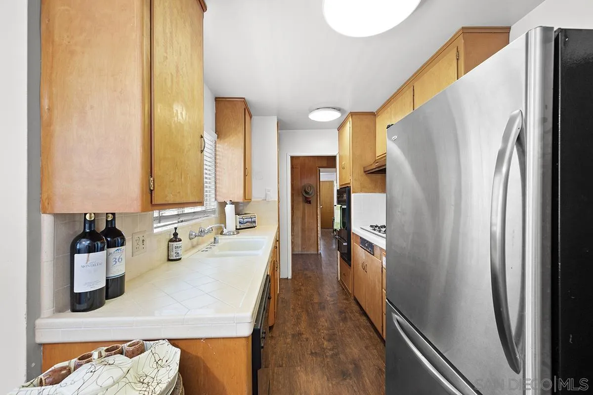 4310 Resmar Road La Mesa, CA 91941 - Photo 21 of 70 a kitchen with refrigerator and countertop