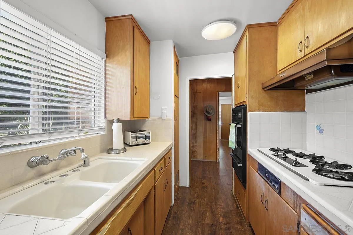 4310 Resmar Road La Mesa, CA 91941 - Photo 22 of 70 a kitchen with stainless steel appliances a sink stove and refrigerator