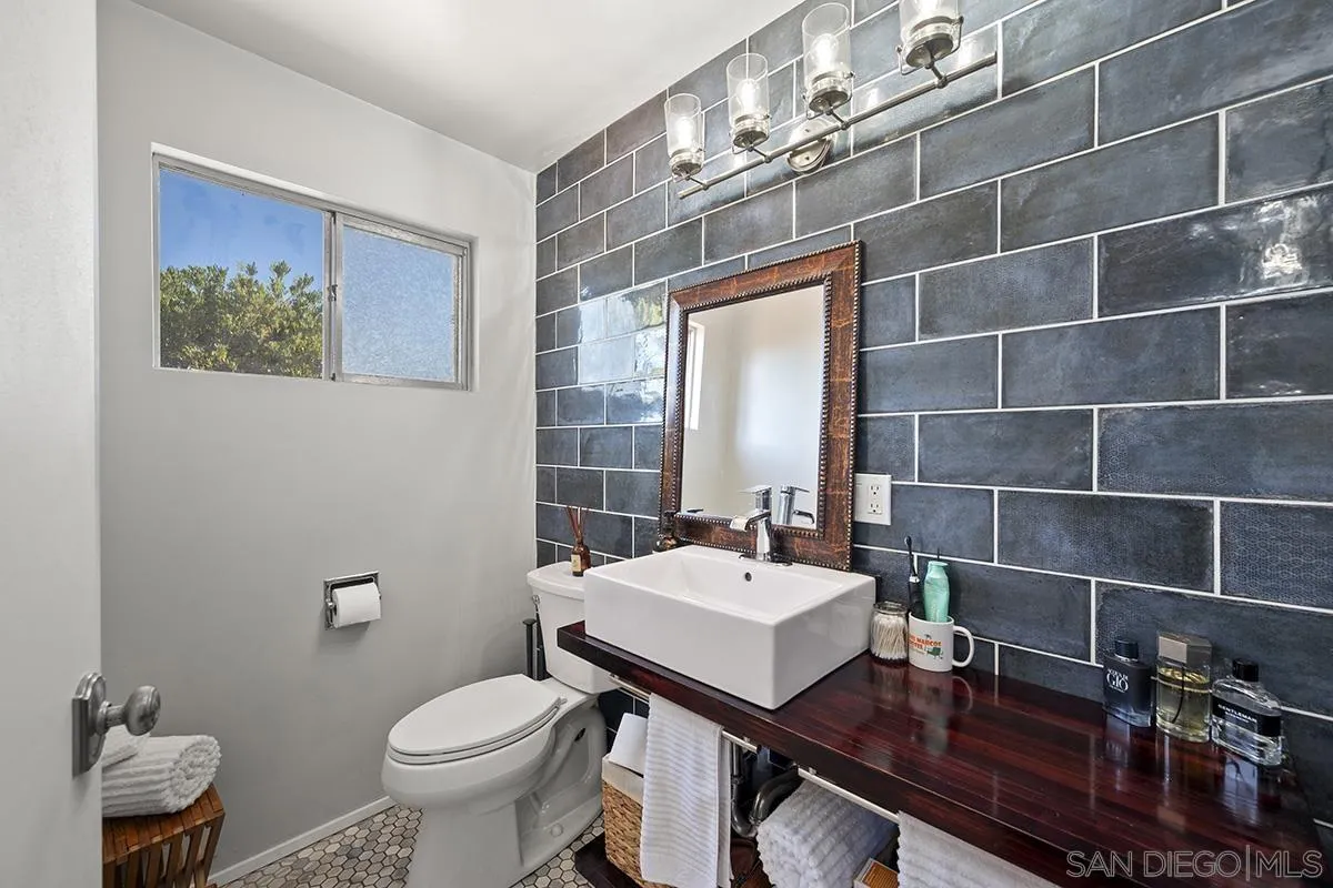 4310 Resmar Road La Mesa, CA 91941 - Photo 28 of 70 a bathroom with a sink a toilet and a mirror