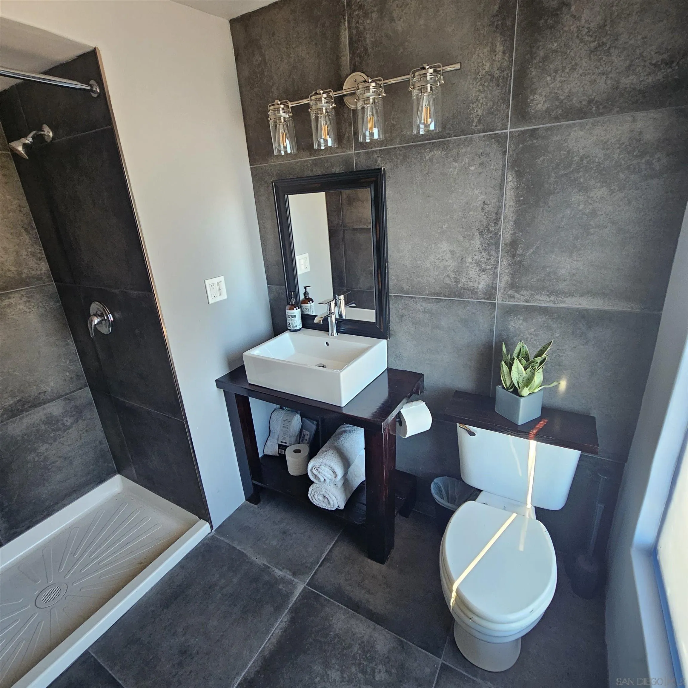 4310 Resmar Road La Mesa, CA 91941 - Photo 39 of 70 a bathroom with a toilet a sink and mirror