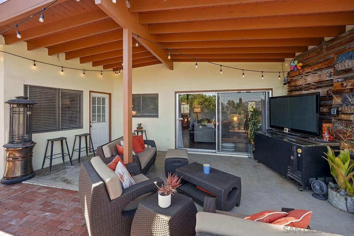4310 Resmar Road La Mesa, CA 91941 - Photo 43 of 70 a living room with furniture a flat screen tv and floor to ceiling window